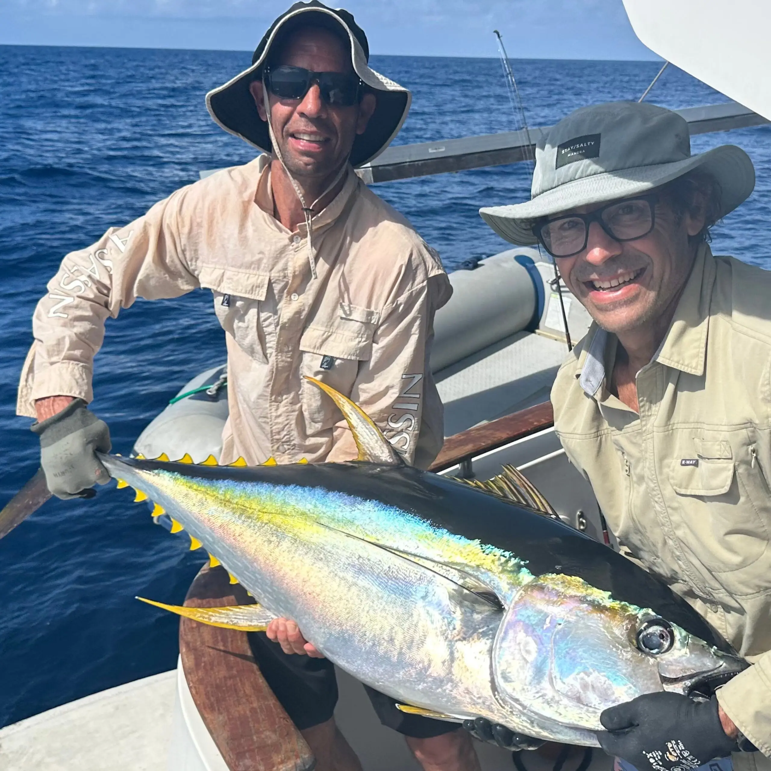 Anglers holding a yellowfin tuna at African Banks Seychelles before release