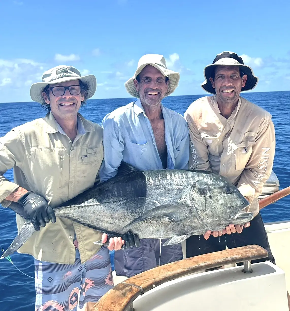 Giant trevally caught during flyfishing trip with anglers on a boat in the ocean.