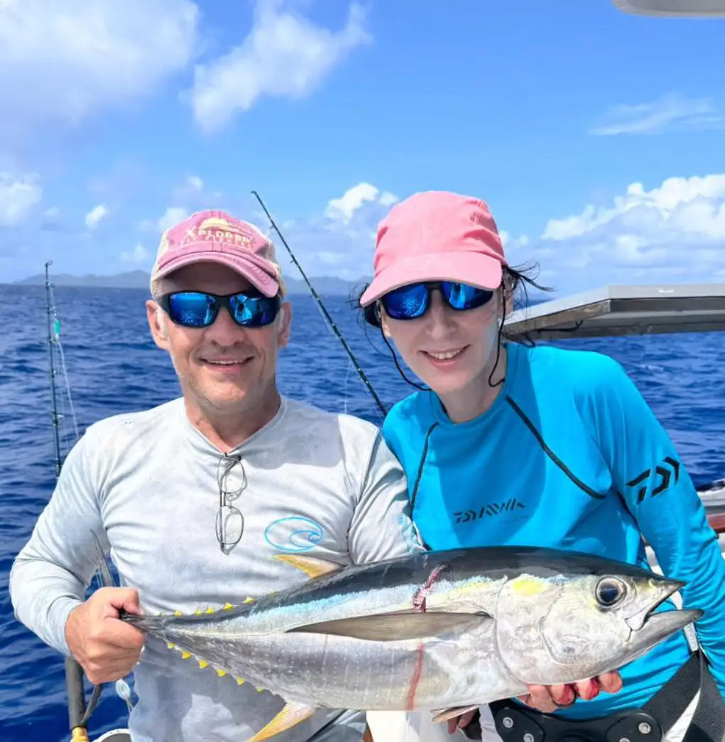 Anglers holding a yellowfin tuna in the Amirantes Seychelles prior to release