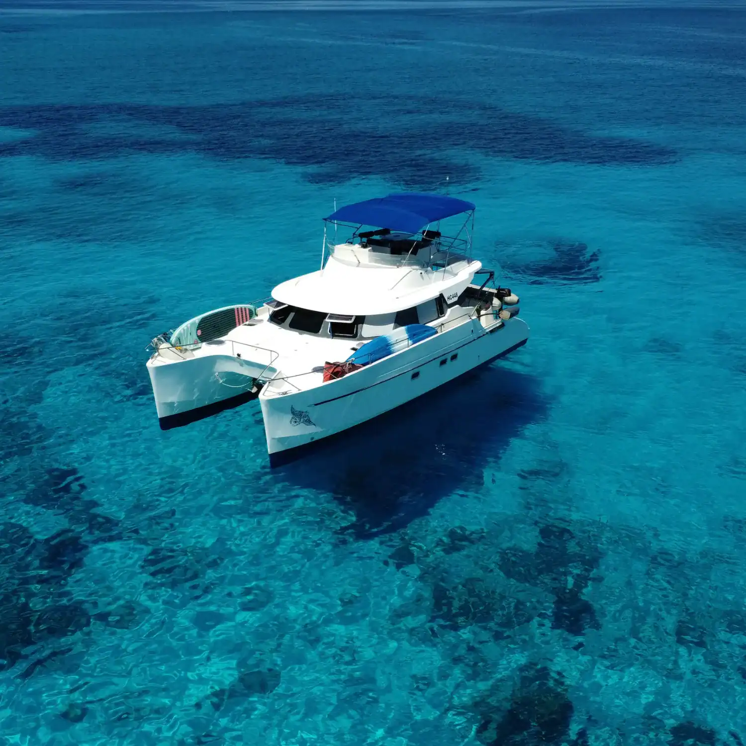 Screaming Reels yacht in clear blue waters Fontaine Pajot Maryland 37 power catamaran resting offshore in calm conditions